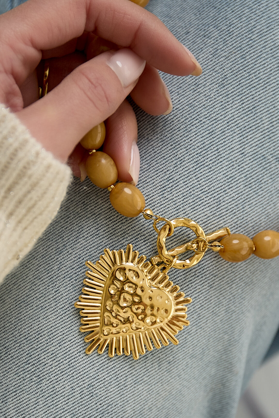 Bead necklace with front closure charm