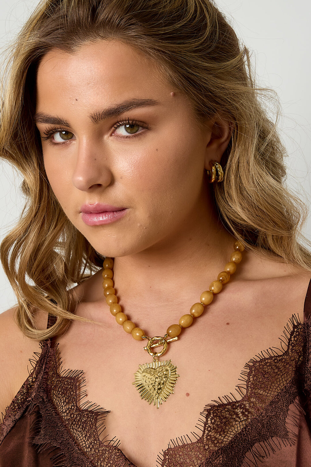 Bead necklace with front closure charm